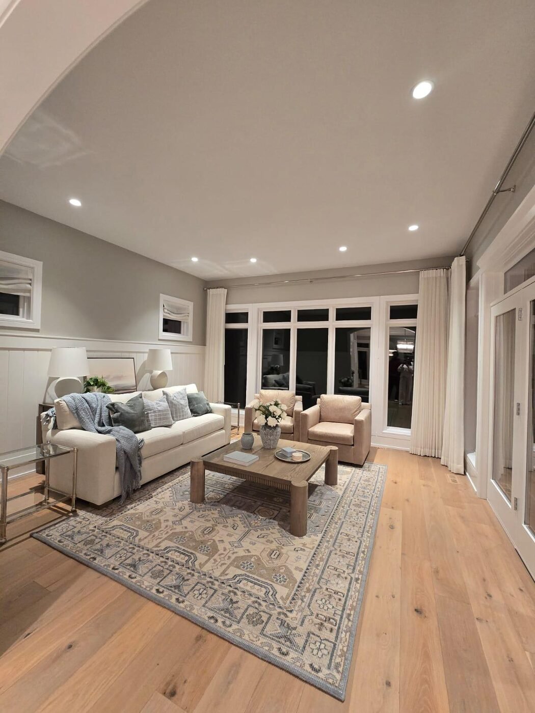 Family room with sofa, armchairs and patterned rug after cleaning