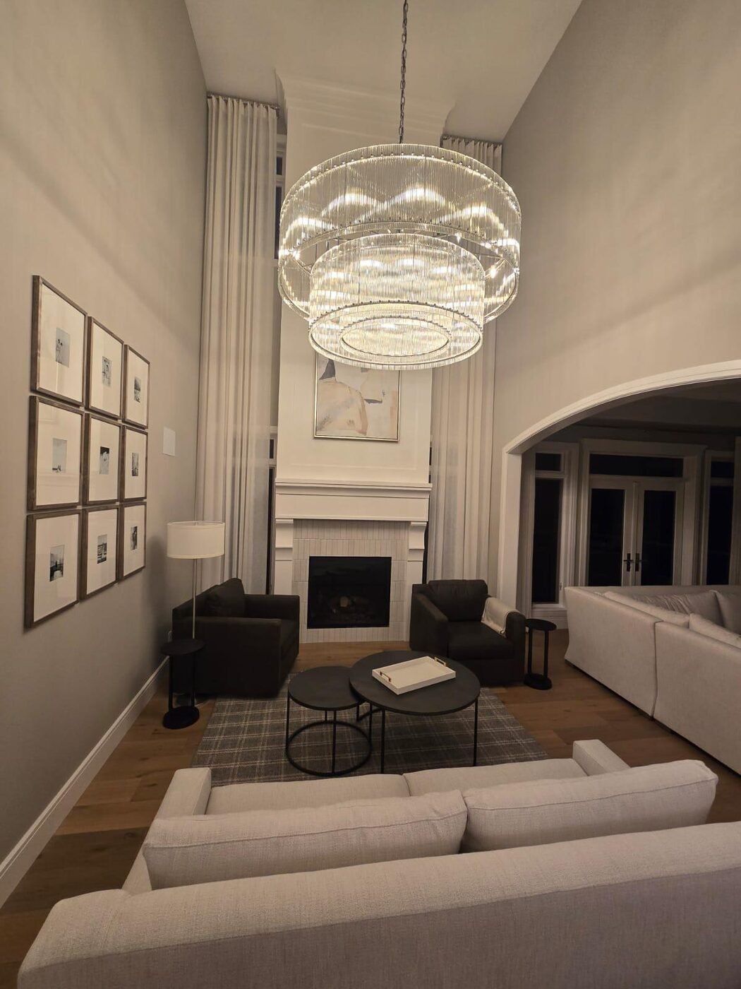 Two-storey great room with chandelier and fireplace after a full deep clean