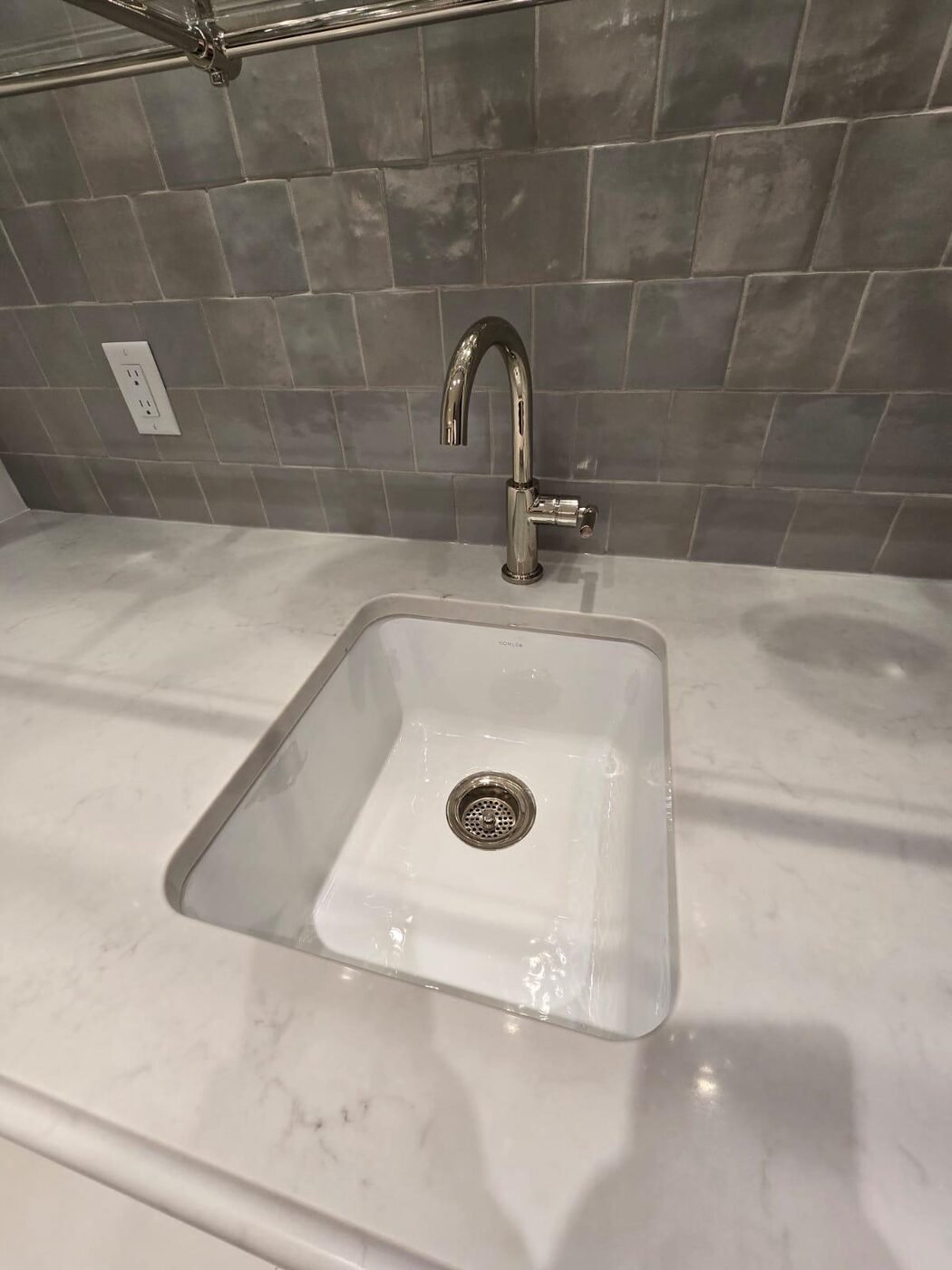 Close view of a farmhouse sink and tap polished to a streak-free finish