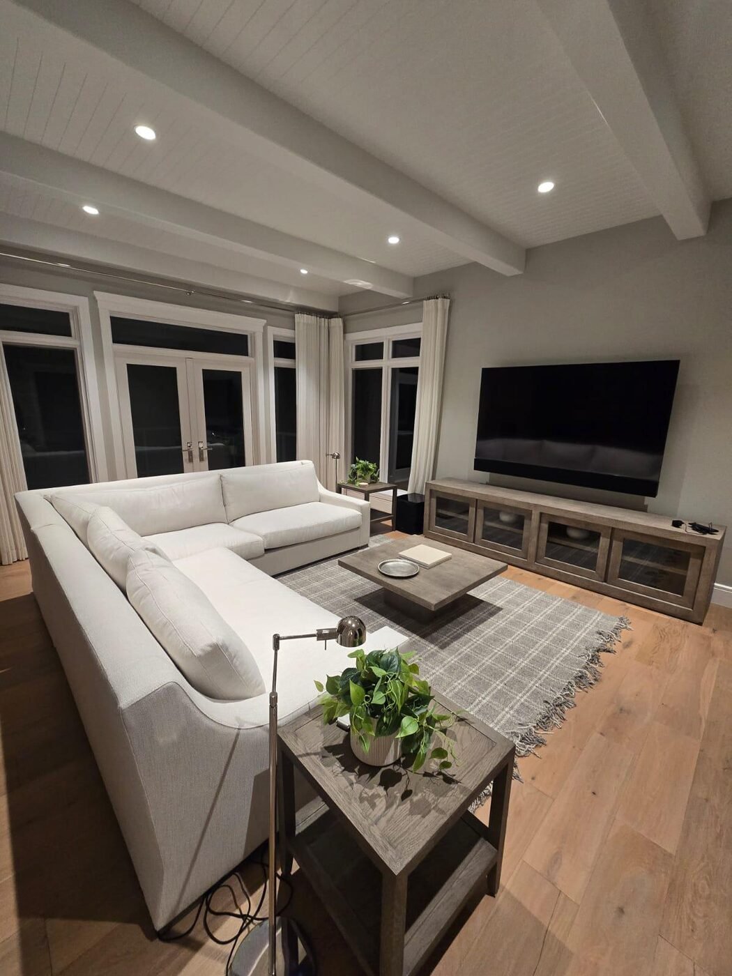 Spotless living room with sectional sofa and hardwood floor, cleaned by SGA Luxe Cleaning Services in Brantford